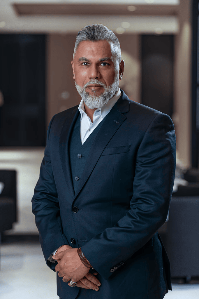 Mansoor, Precision Health Clinic team member, professional headshot in dark suit